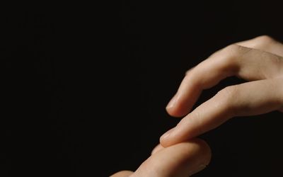 Close-up of hands in a meditative gesture.